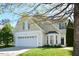 Charming two-story home featuring a manicured lawn, attached garage, and delightful bay window at 1914 Woodsdale Dr, Durham, NC 27703