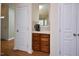 Hallway with built-in coffee bar and storage features white doors and hardwood floors at 1914 Woodsdale Dr, Durham, NC 27703
