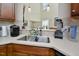 The open kitchen features stainless steel sink, stylish backsplash, and modern appliances at 1914 Woodsdale Dr, Durham, NC 27703