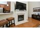 Elegant living room featuring a fireplace, hardwood floors, and an open layout to the kitchen at 1914 Woodsdale Dr, Durham, NC 27703