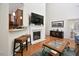 Cozy living room with a fireplace and hardwood floors, complemented by stylish furnishings at 1914 Woodsdale Dr, Durham, NC 27703