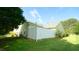 Exterior shot of a well-manicured lawn, a vinyl fence, and partial view of the house at 201 Blithe Pl, Morrisville, NC 27560