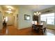 Dining room featuring a dining table with chairs, lighting fixtures, and hardwood floors at 201 Blithe Pl, Morrisville, NC 27560