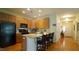 Well-designed kitchen with granite countertops, stainless steel appliances, and a breakfast bar with seating at 201 Blithe Pl, Morrisville, NC 27560