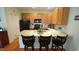 Stylish kitchen featuring a large island with seating, modern appliances, and ample cabinet space at 201 Blithe Pl, Morrisville, NC 27560