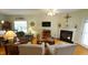 Bright living room with a fireplace, comfortable seating, and a ceiling fan at 201 Blithe Pl, Morrisville, NC 27560