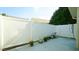 Back patio featuring a white privacy fence, green foliage, and space for seating at 201 Blithe Pl, Morrisville, NC 27560