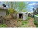 Backyard area with a shed, sparse grass, foliage, and a glimpse of the side of a home at 229 Watson Dr, Burlington, NC 27217