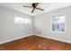 A simple bedroom features two windows and a hardwood floor at 229 Watson Dr, Burlington, NC 27217