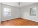 A simple bedroom features two windows and a hardwood floor at 229 Watson Dr, Burlington, NC 27217