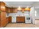 Well-lit kitchen featuring essential appliances and plenty of cabinet storage at 229 Watson Dr, Burlington, NC 27217