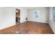 Empty living room with hardwood floors and a window overlooking the yard at 229 Watson Dr, Burlington, NC 27217
