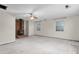 A spacious living room features a wood-burning fireplace, ceiling fan, and two windows at 229 Watson Dr, Burlington, NC 27217