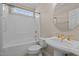 Bathroom featuring a pedestal sink and tub with shower in neutral tones at 252 Shea Ct, Graham, NC 27253