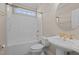 Bathroom featuring a pedestal sink and tub with shower in neutral tones at 252 Shea Ct, Graham, NC 27253