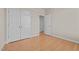 Bedroom with light hardwood floors, closet and open doorway to another room at 252 Shea Ct, Graham, NC 27253