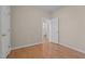 Bedroom with neutral walls, light hardwood flooring, closet and open doorway to a bathroom at 252 Shea Ct, Graham, NC 27253