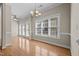 A formal dining room with elegant chandelier and natural light coming in from large window at 252 Shea Ct, Graham, NC 27253