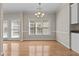 Dining area with chandelier, large window, and hardwood floors at 252 Shea Ct, Graham, NC 27253