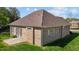Brick home features a well maintained lawn, patio, and neutral shingles at 252 Shea Ct, Graham, NC 27253