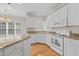 Bright kitchen with white cabinetry, granite counters, and modern appliances at 252 Shea Ct, Graham, NC 27253