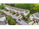 Aerial view of a townhome community featuring tree-lined streets, well-maintained lawns, and ample parking at 265 Mariah Towns Way, Garner, NC 27529