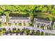 Aerial view of a townhome community featuring tree-lined streets, well-maintained lawns, and ample parking at 265 Mariah Towns Way, Garner, NC 27529
