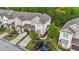 Aerial view of a townhome community featuring well-maintained lawns, driveways, and tree-lined streets at 265 Mariah Towns Way, Garner, NC 27529