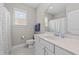 Well-lit bathroom featuring a marble countertop vanity and a shower at 265 Mariah Towns Way, Garner, NC 27529