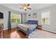 Stylish bedroom with hardwood floors, natural light, and blue accents at 265 Mariah Towns Way, Garner, NC 27529