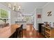 Open dining area with wood floors, stylish chandelier, and granite counter looking into the kitchen at 265 Mariah Towns Way, Garner, NC 27529