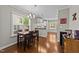 Dining area with a wooden table set, hardwood floors, and natural light at 265 Mariah Towns Way, Garner, NC 27529
