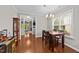 Dining room with a wood table set with chairs, chandelier, and hardwood flooring at 265 Mariah Towns Way, Garner, NC 27529