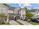 Inviting townhouse with a two-car garage, manicured lawn, and stylish neutral-toned exterior at 265 Mariah Towns Way, Garner, NC 27529