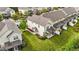 Aerial view of townhomes featuring manicured lawns, covered patios, and tasteful landscaping on a sunny day at 265 Mariah Towns Way, Garner, NC 27529
