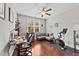 Home office featuring desk, couch, and Peloton bike with hardwood flooring and a ceiling fan at 265 Mariah Towns Way, Garner, NC 27529