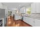 Kitchen featuring white cabinets, granite countertops, stainless steel appliances, and hardwood flooring at 265 Mariah Towns Way, Garner, NC 27529