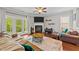 Comfortable living room with hardwood floors, fireplace, and plenty of natural light at 265 Mariah Towns Way, Garner, NC 27529