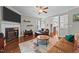 Inviting living room with fireplace, hardwood floors, and open access to other rooms at 265 Mariah Towns Way, Garner, NC 27529