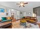 Bright living room with hardwood floors, comfortable leather seating, and open floor plan at 265 Mariah Towns Way, Garner, NC 27529