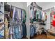 Organized walk-in closet with double hanging rods for shirts and pants, and shelves for accessories and containers at 265 Mariah Towns Way, Garner, NC 27529