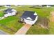 Stunning aerial view of a home with a long driveway, lush lawn and scenic surroundings at 295 Springtooth Dr, Zebulon, NC 27597