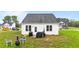 View of the back of the house with outdoor furniture and clear windows at 295 Springtooth Dr, Zebulon, NC 27597