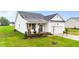 Attractive single-Gathering home with a manicured lawn and charming front porch featuring chairs at 295 Springtooth Dr, Zebulon, NC 27597