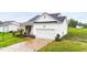 Beautiful single-Gathering home boasting a manicured lawn and inviting front porch with chairs at 295 Springtooth Dr, Zebulon, NC 27597