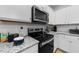 Well-equipped kitchen with granite countertops, stainless steel appliances, and ample cabinet space for cooking at 295 Springtooth Dr, Zebulon, NC 27597