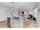 Bright and airy kitchen with a granite island, stainless steel dishwasher, and open access to a living space at 295 Springtooth Dr, Zebulon, NC 27597
