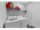 Practical laundry room equipped with washer, dryer, and storage shelving at 295 Springtooth Dr, Zebulon, NC 27597