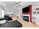 Open-concept living space with modern fireplace, kitchen access, and comfortable seating at 295 Springtooth Dr, Zebulon, NC 27597