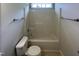 Clean bathroom featuring a tub and shower combination with neutral tile and coordinated fixtures at 312 Sarazen Dr, Clayton, NC 27527